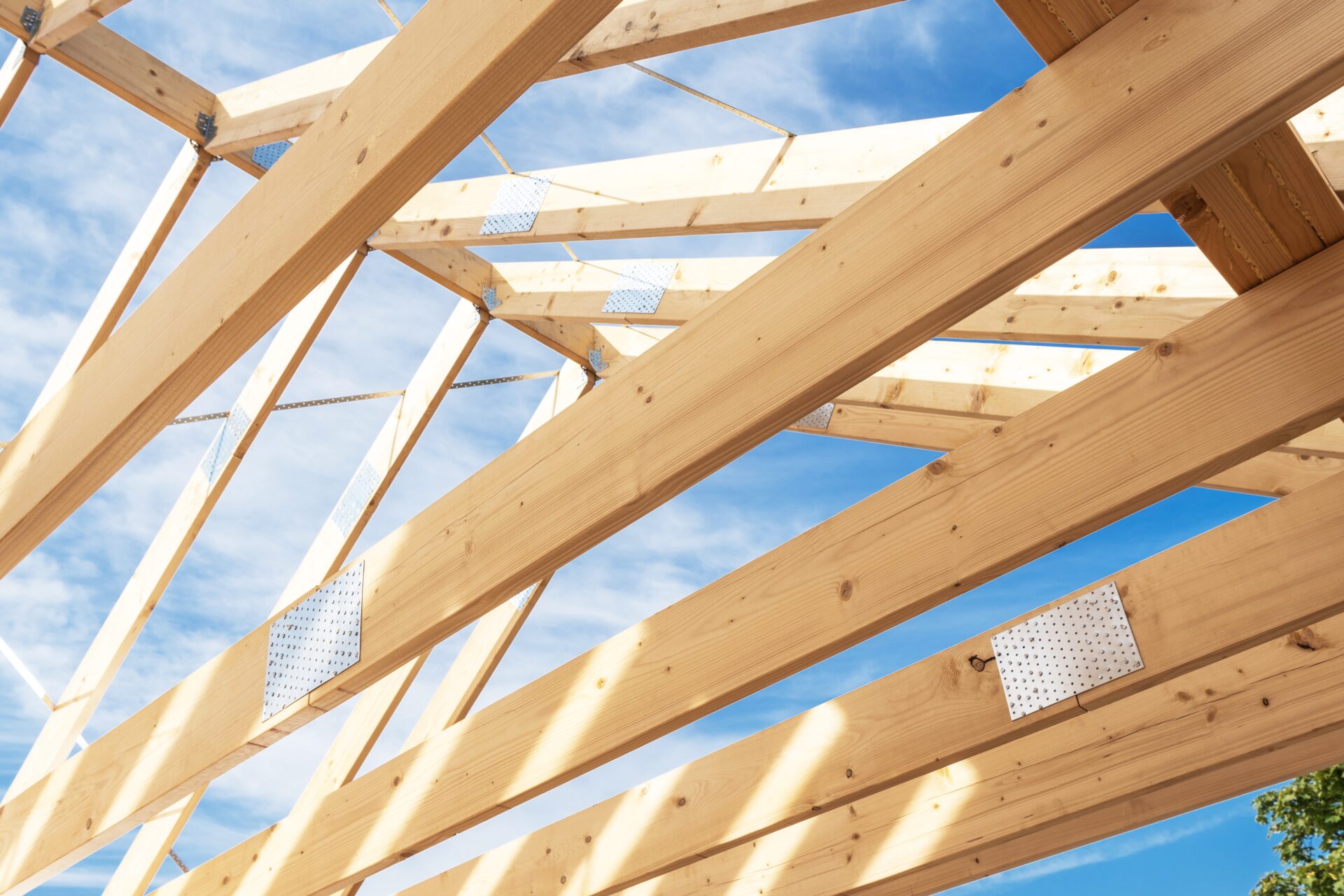 Workers,Are,Constructing,A,Wooden,Roof,Frame,,Showcasing,Sturdy,Beams